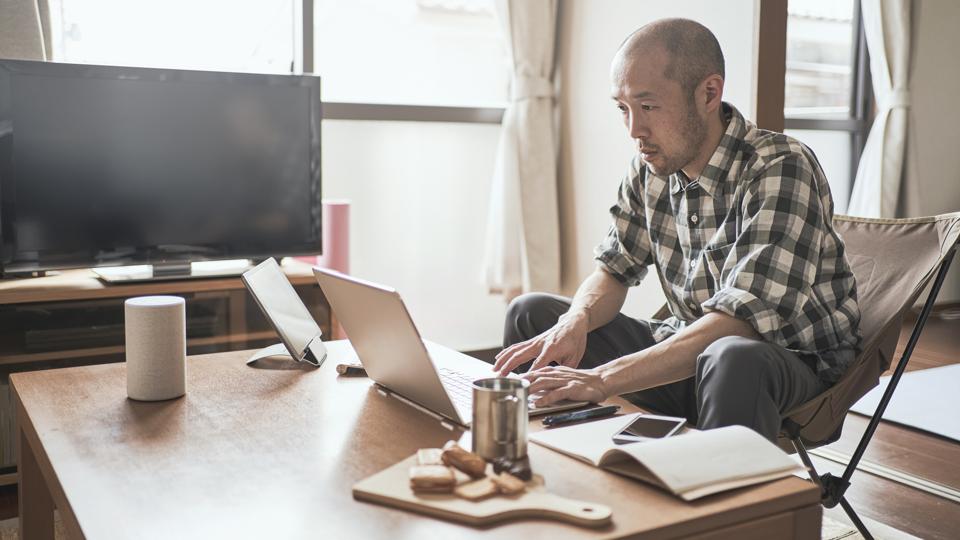 Asian male worker working from Home.