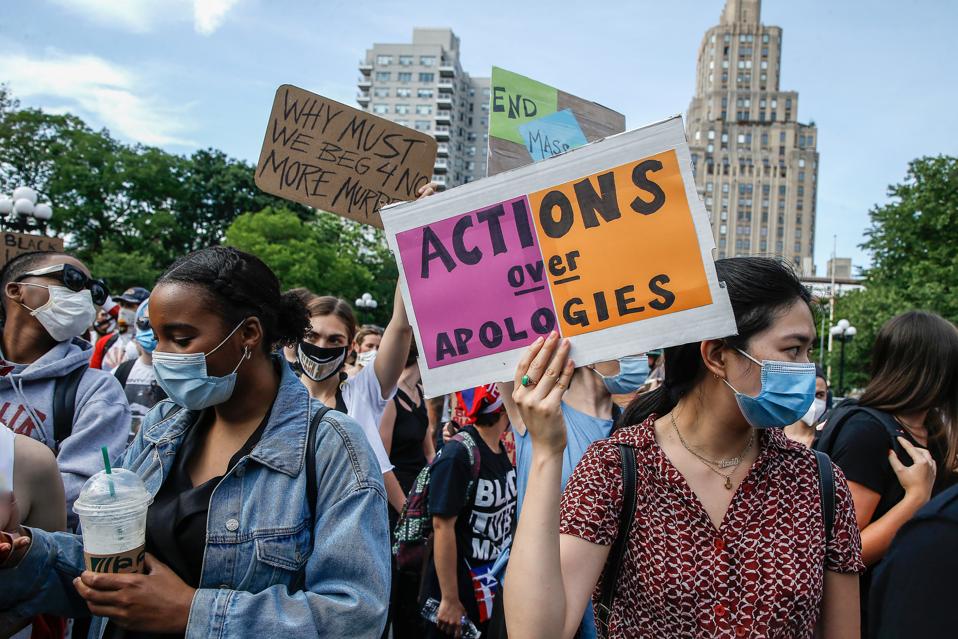 Black Lives Matter Demonstrators hold placards