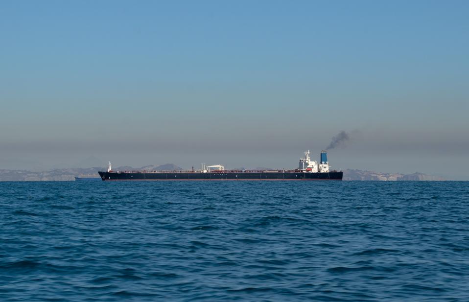 Large oil tanker ship smoking sails Strait of Hormuz, Persian Gulf, Iran