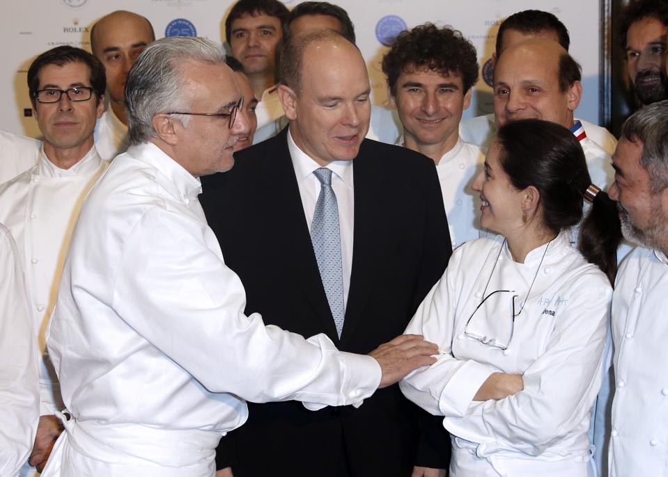French chef Alain Ducasse and Prince's Albert II of Monaco (C) greet chef Elena Arzak Espina (R) during the festivities marking the 25th anniversary of Ducasse's restaurant ″Le Louis XV″, on November 17, 2012 in Monaco. Arzak is one of the female chefs featured in ″A Fine Line″ AFP PHOTO / VALERY HACHE (Photo credit should read VALERY HACHE/AFP via Getty Images)
