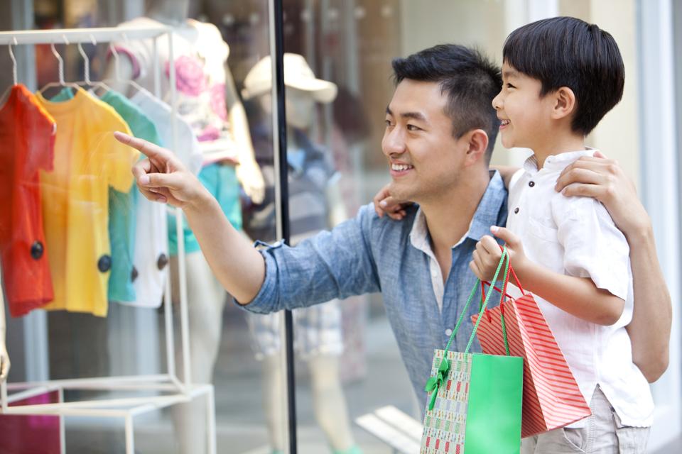 Father and son shopping in department store