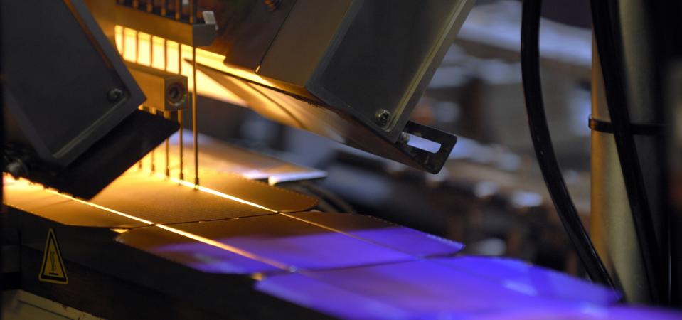 Solar cells wafers as they pass through a machine during the...