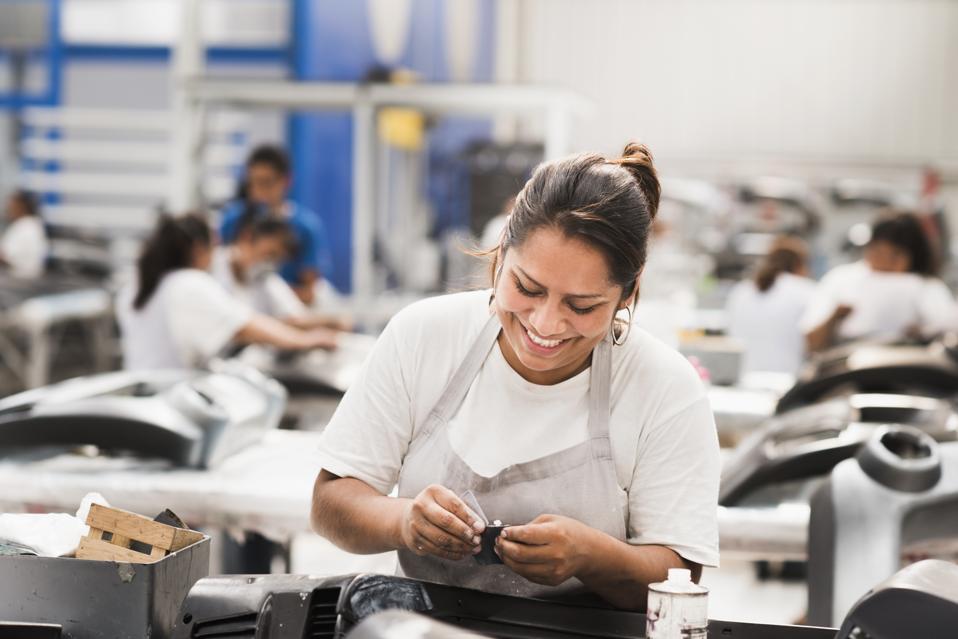 Worker smiling in manufacturing plant