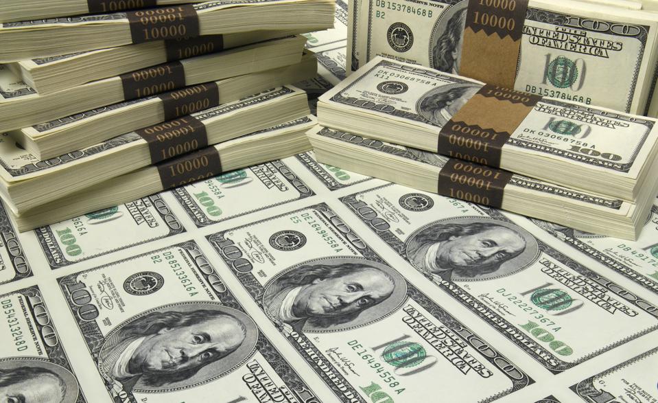 Stacks and sheet of US one hundred dollar bills, elevated view