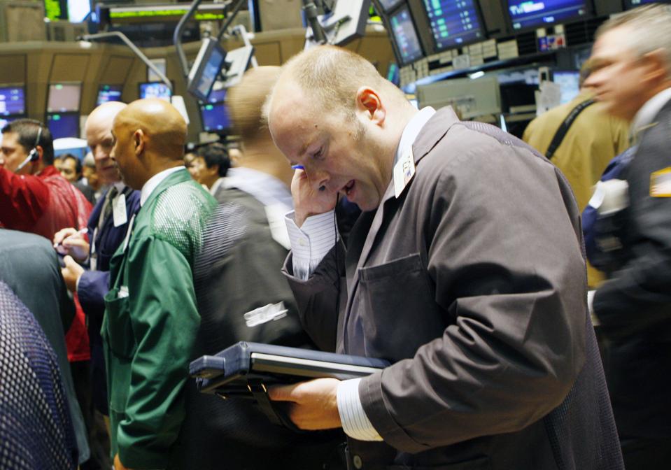 Traders work on the floor of the New York Stock Exchange in New York, U.S., on Wednesday, July 9, 2008. U.S. stocks declined as analysts said a slowing economy may hurt sales at technology companies and oil prices rose for the first time this week after Iran test-fired a missile capable of reaching Israel. Photographer: Andrew Harrer/Bloomberg News