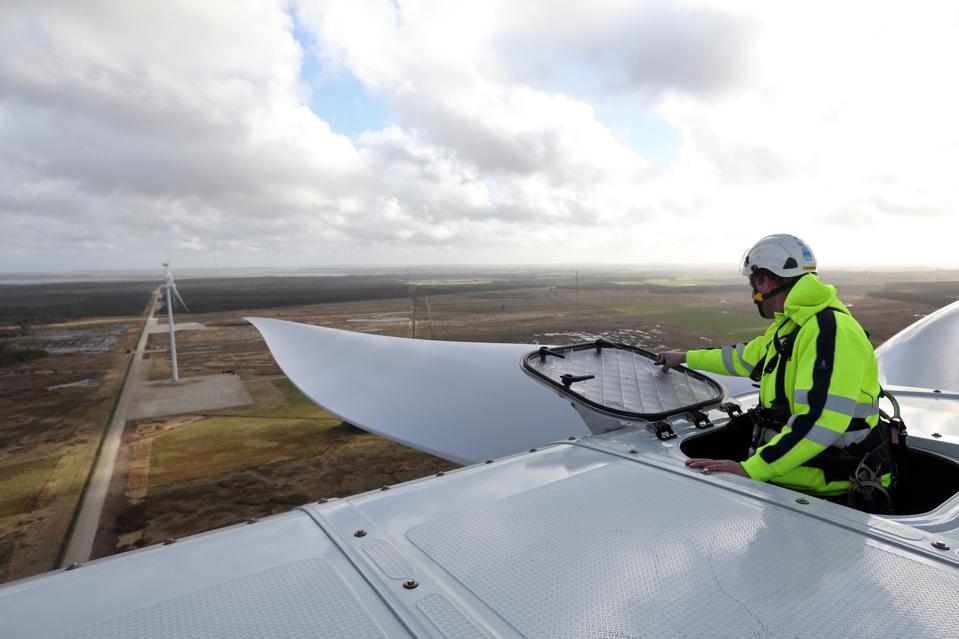 An employee prepares to climb onto the nacelle of a Vestas wind turbine in Denmark.