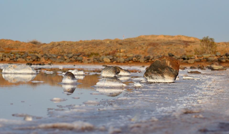 Stones in the shore of salted lagoon beside the sea