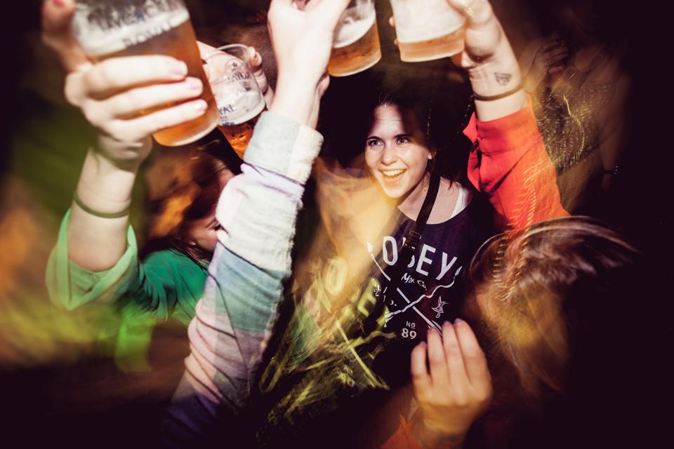A group of girls saying cheers and are having ice cold drafted beer at the local nightclub. Denmark 2012.