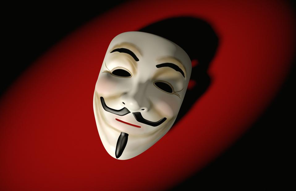 Mask of Guy Fawkes, as associated with the Anonymous hacktivist collective, against a red background