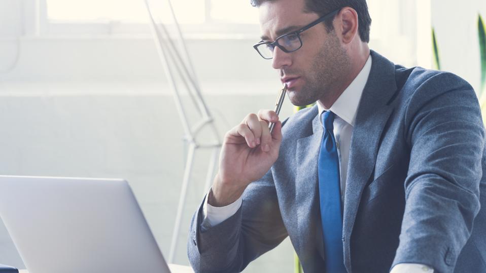Businessman working on laptop computer.