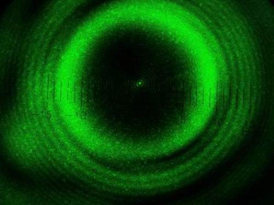 The results of an experiment, showcased using laser light around a spherical object.