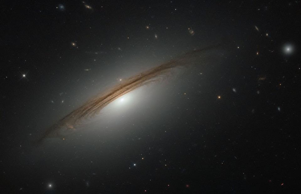 This unusual galaxy is partway between the evolution from a spiral to a lenticular galaxy.