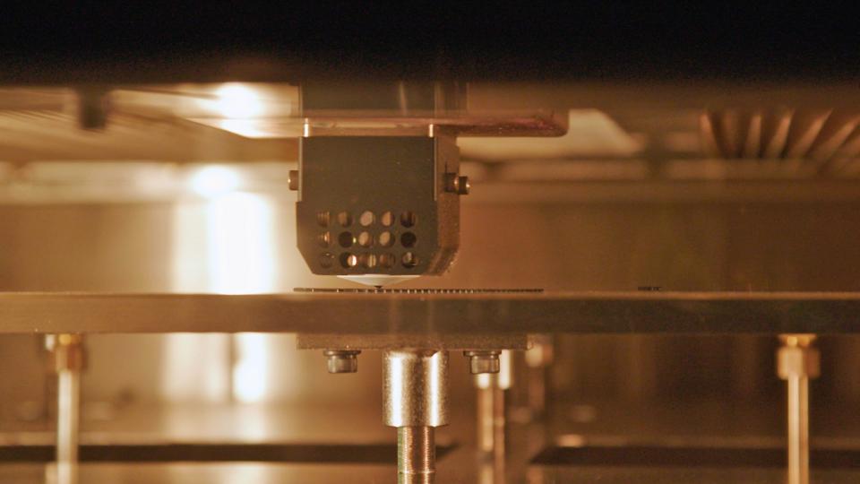 A train armrest being printed on a Stratasys printer.