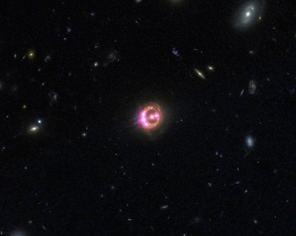 Combination image of quasar RX J1131 (center) taken via NASA’s Chandra and Hubble.