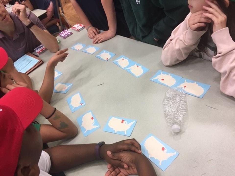 Kids compete at a geography card game tournament.