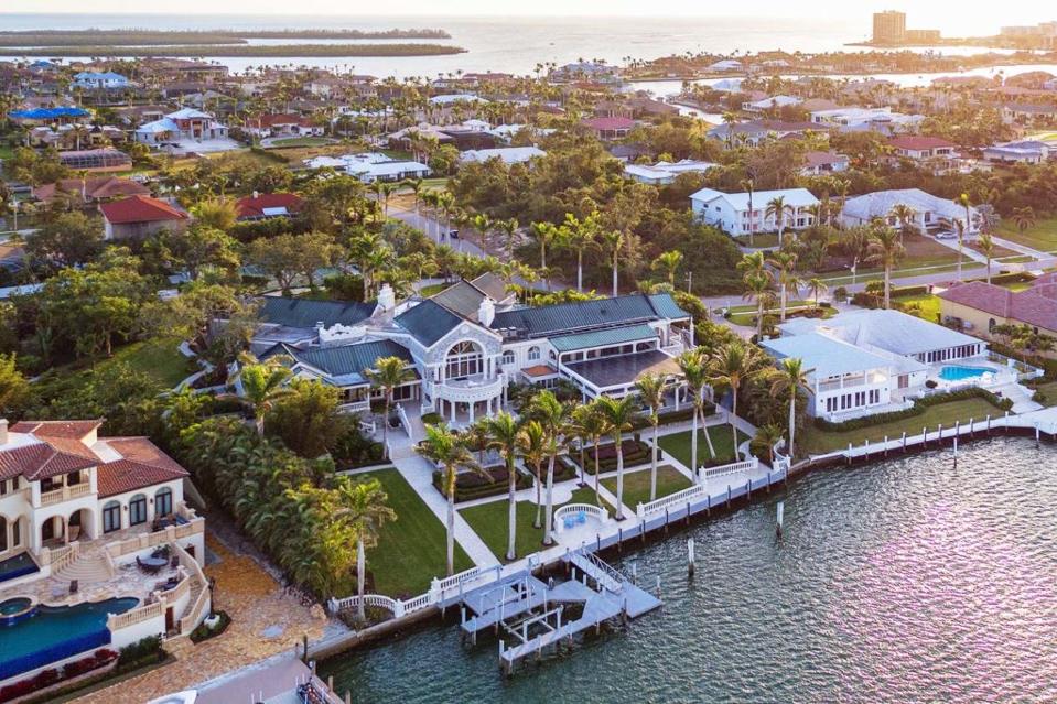 A waterfront estate in Florida surrounded by palm trees.
