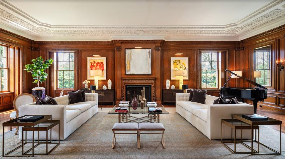 A sprawling living space, flanked with ornate wood panels.