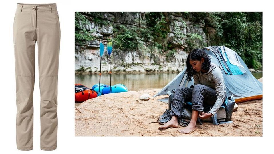 Craghoppers hiking pants and woman on beach in hiking pants with kayaks and tent