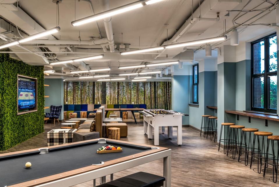 Student lounge with green wall, foosball table and billiards