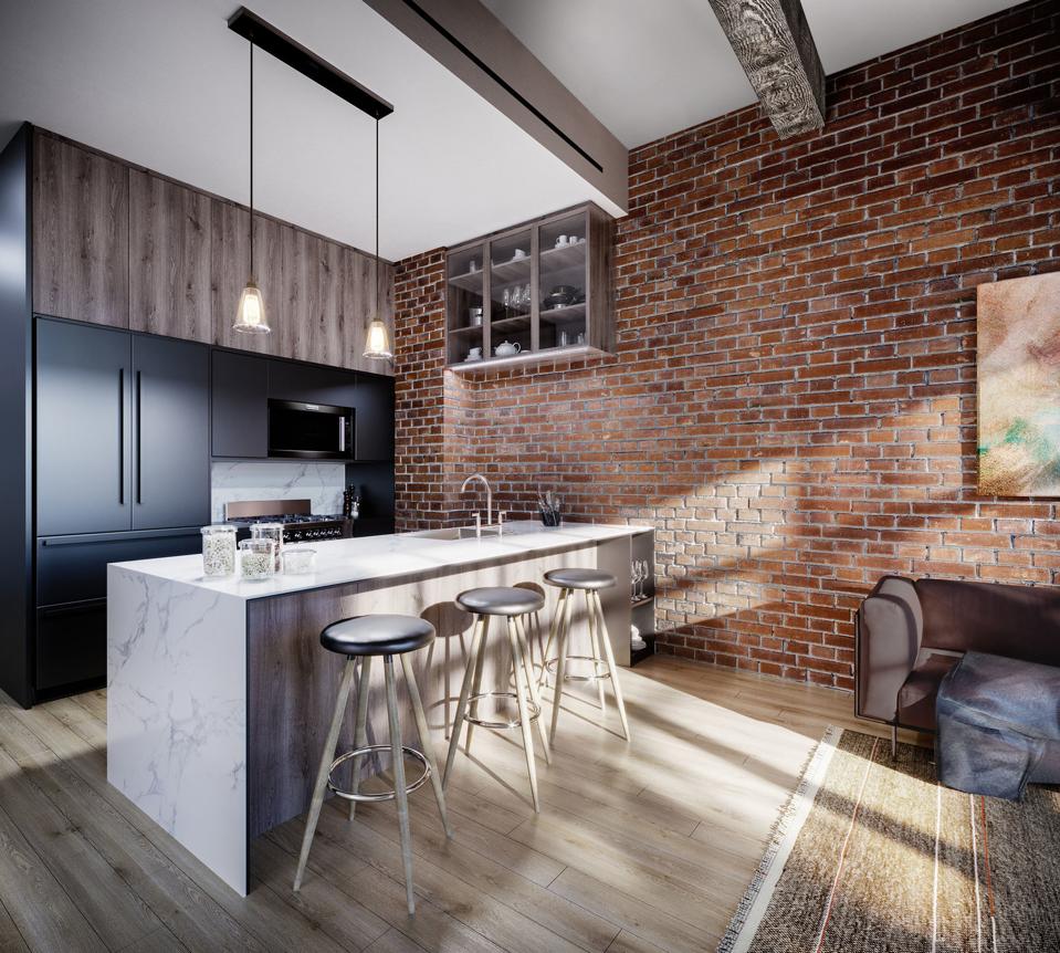 A kitchen island in front of exposed brick.