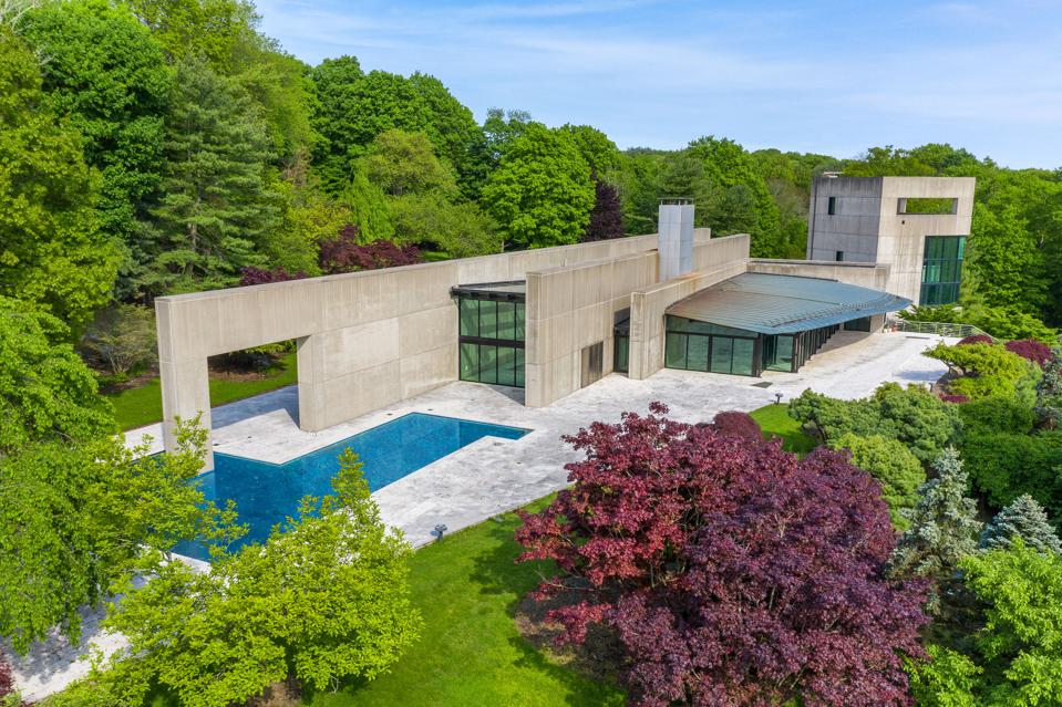 An aerial shot of a concrete and glass home.
