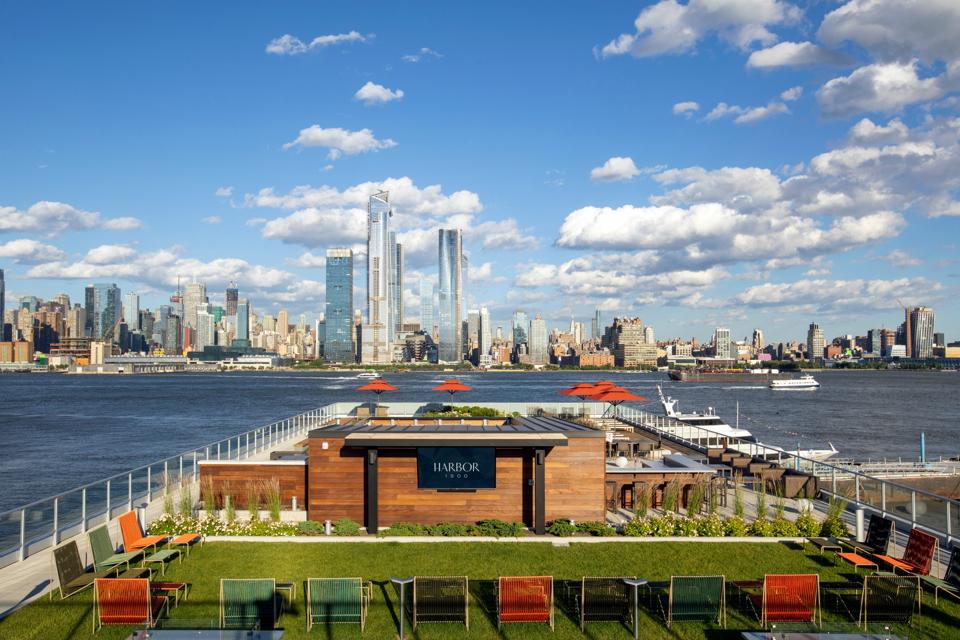 A roof deck with a view of the Manhattan skyline.
