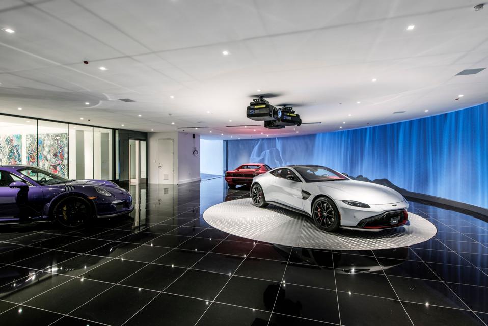 The McLaren, Aston Martin and Porsche that come with the listing.