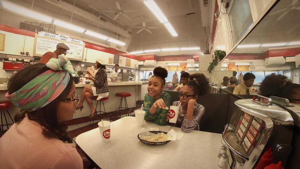 Image shows young girls at Ben's Chili Bowl in 'Traveling While Black'