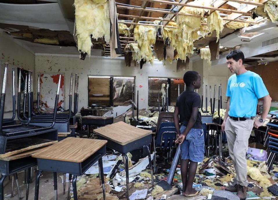 On September 7, 2019, in Marsh Harbour, Abaco Island, Bahamas, 10-year-old Torres talks to UNICEF’s Regional Emergency Specialist Hanoch Barlevi in the ruins of his classroom at the Central Abaco Primary School.