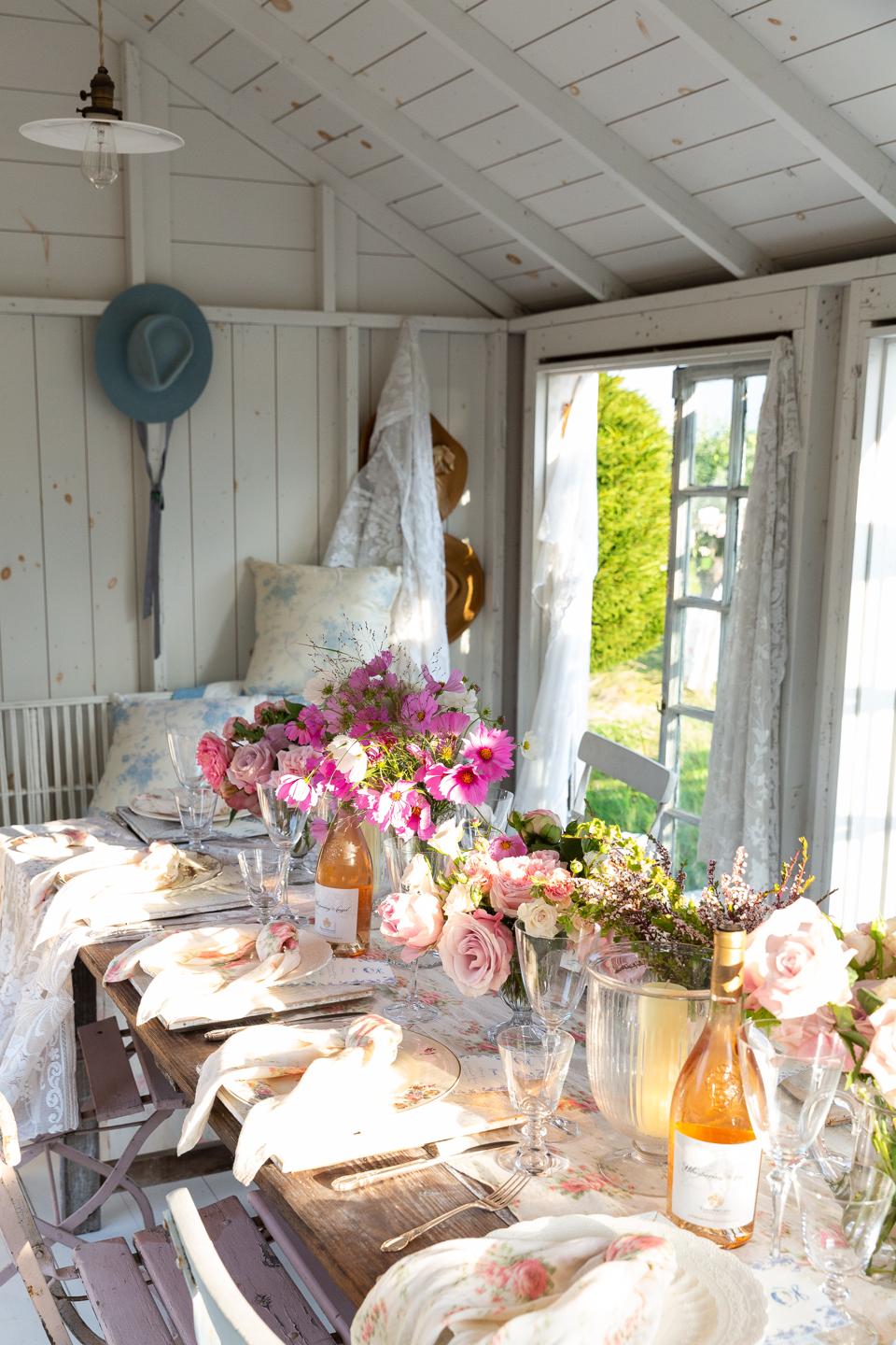 A dinner table set with linens from LoveShackFancy's new home offerings at Cohen's family summer home in Watermill.