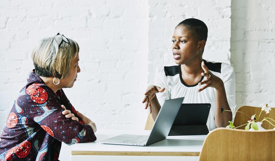 Female financial advisor in discussion with client in office conference room