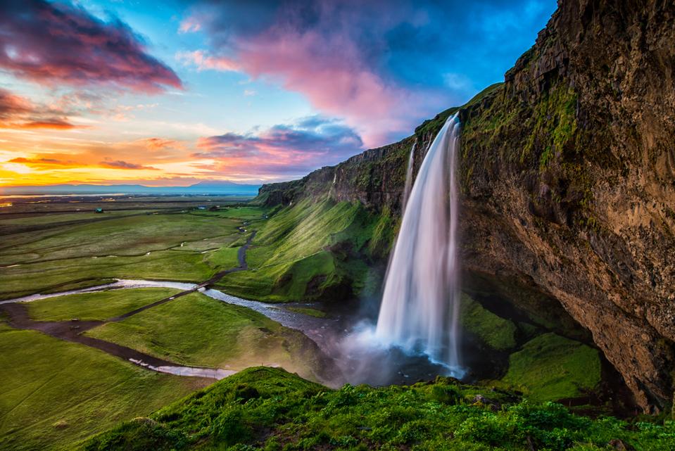 Travelers visit Iceland to see Seljalandsfoss.