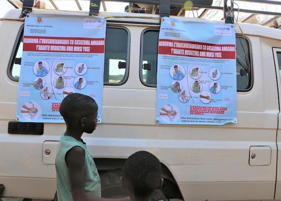 In Gatumba, Burundi in August 2019, a boy examines posters as part of an Ebola awareness campaign organized by UNICEF Burundi's Communication for Development (C4D) team.