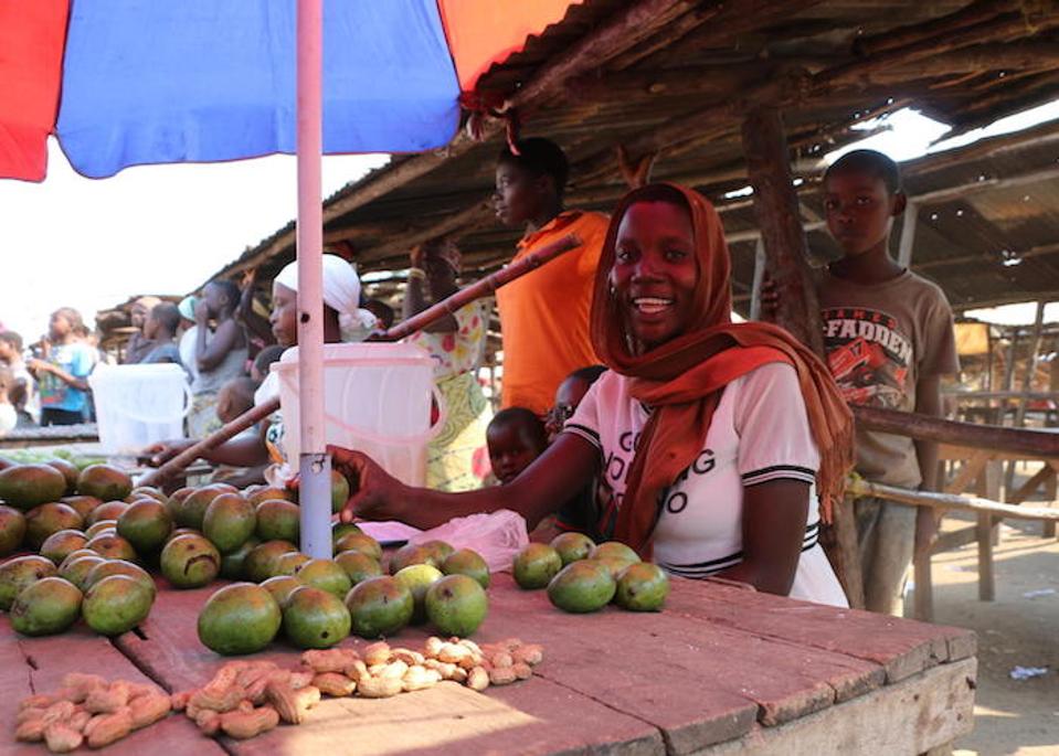 Estelle Nikoyagize, 23, sells mangoes in the market in Gatumba, Burundi, interacting daily with suppliers from neighboring Democratic Republic of Congo, where health workers have been battling an Ebola outbreak for more than a year.