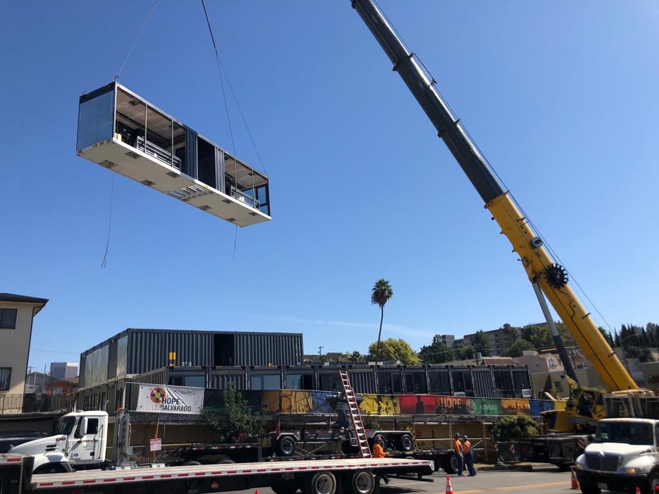 The 84-unit development was unveiled with a viewing event where multiple modular sections were lifted into place, demonstrating the efficiency of construction.