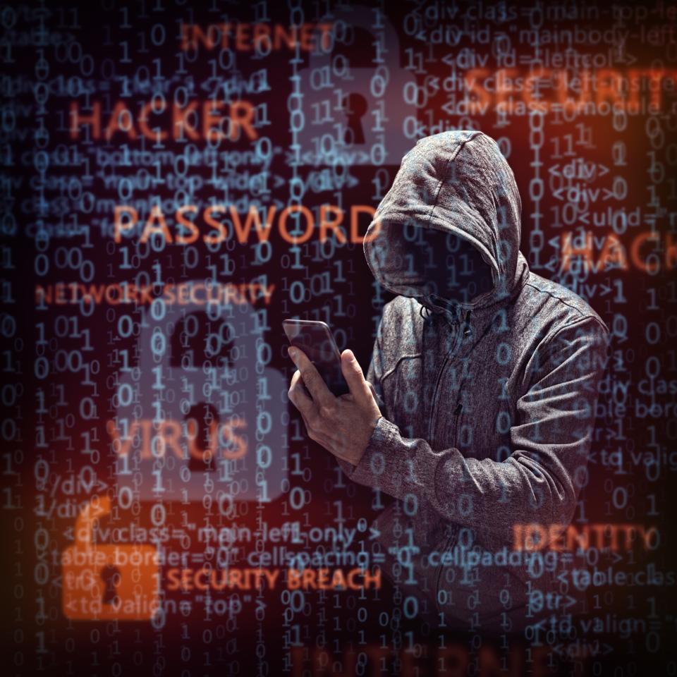 Computer hacker with mobile phone.