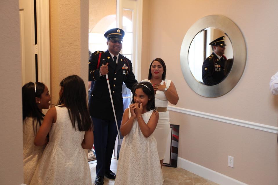 Blind veteran and family in donated home