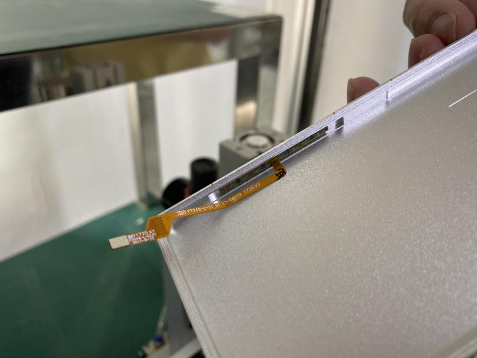 An NDT engineer demonstrates how the sensors are applied to a phone.