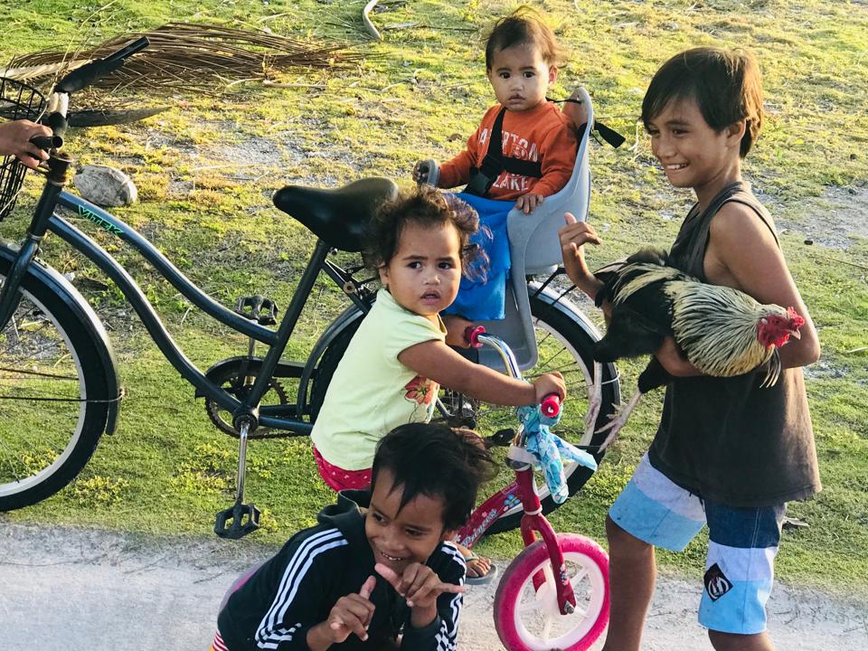 Children with rooster and push bikes