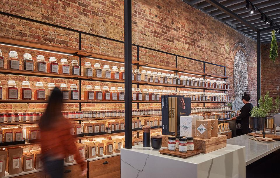 A mix of contemporary fixtures, contrasted with locally sourced heritage pieces, provides a backdrop for the richly textured variety of spices.