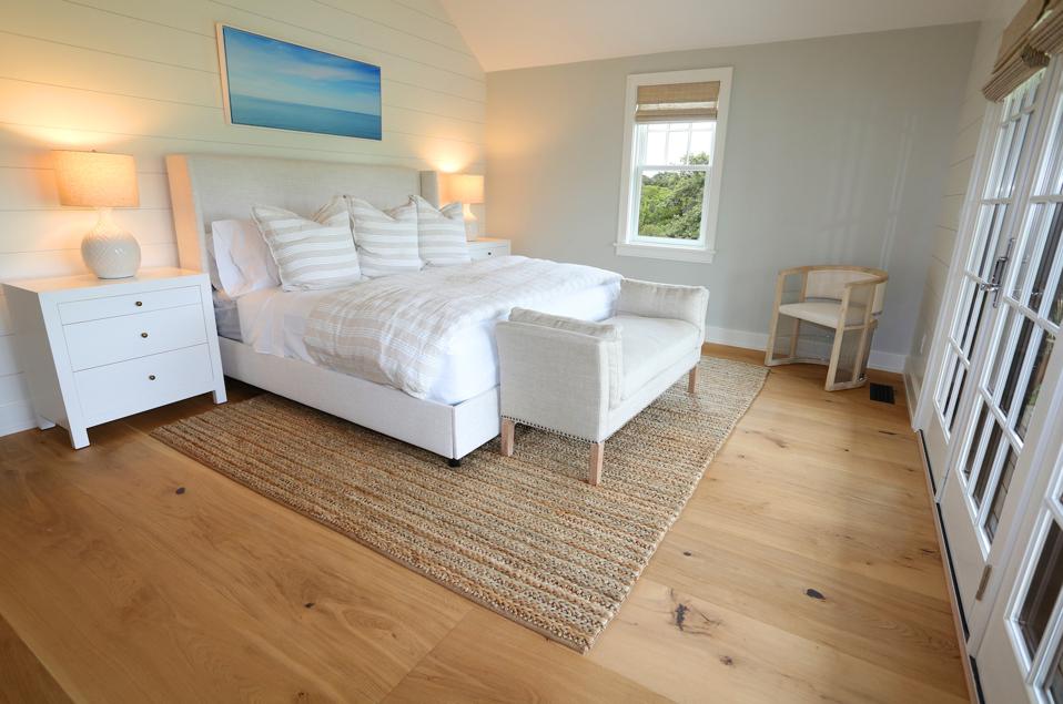 The engineered wood is carried throughout this house, including the bedroom.