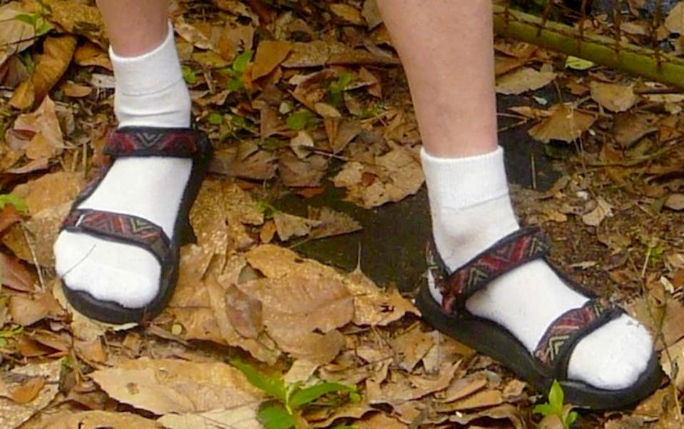 Socks and sandals worn together.