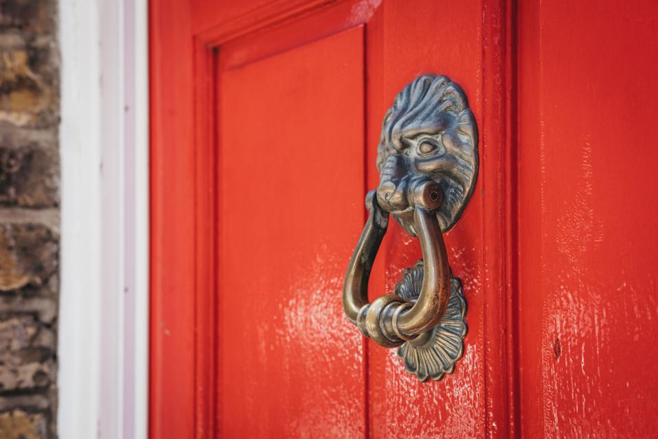 A red door with lion knocker.