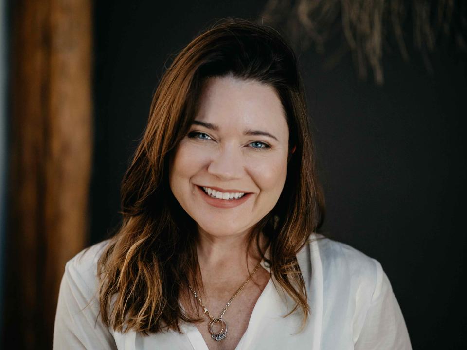 Headshot of Beth Massa in white blouse.