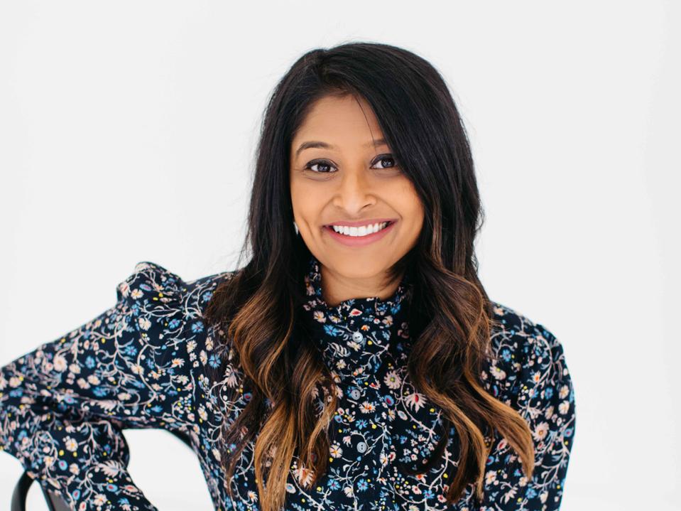Headshot of Roma Patel in flowered dress.