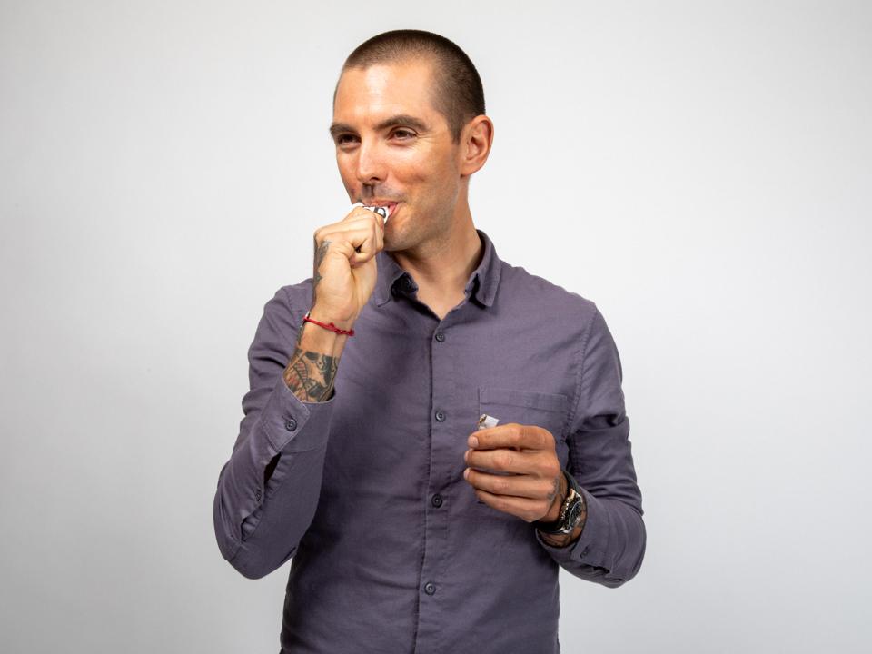 Headshot of Jeff Mahin sucking on a small package.