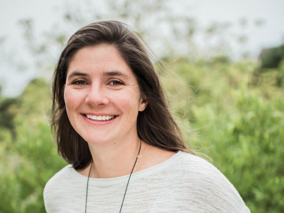 Headshot of Alison Mountford in front of a green field.