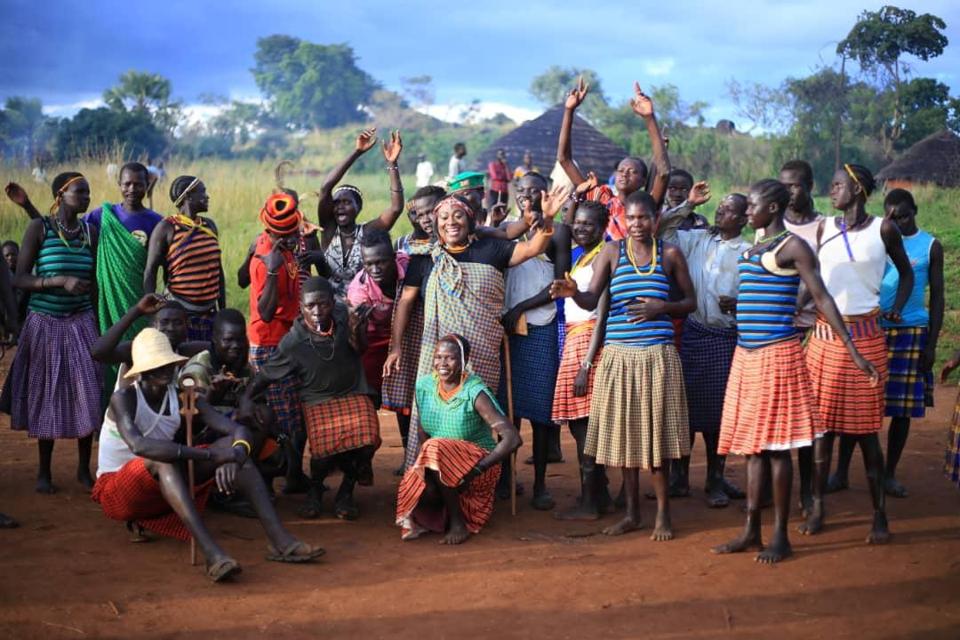 A group of young African women celebrating in rural Uganda.