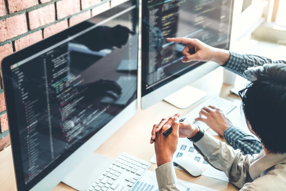 Programmers Coding In Office