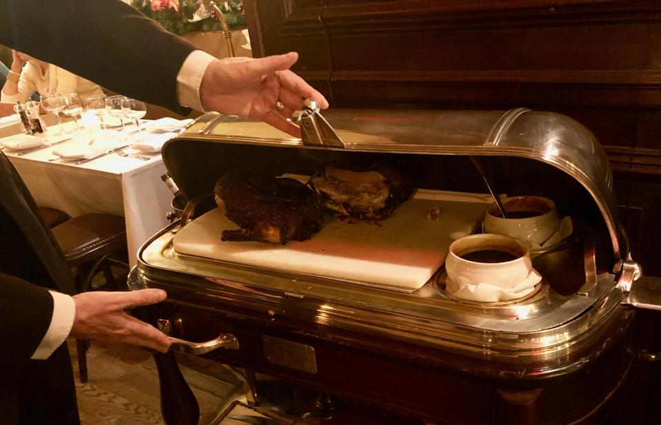 At La Goulue in New York, canard à l'orange awaits the carving knife under a silver plated dome.